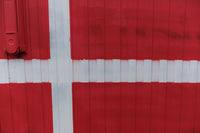 A close up of a red and white door