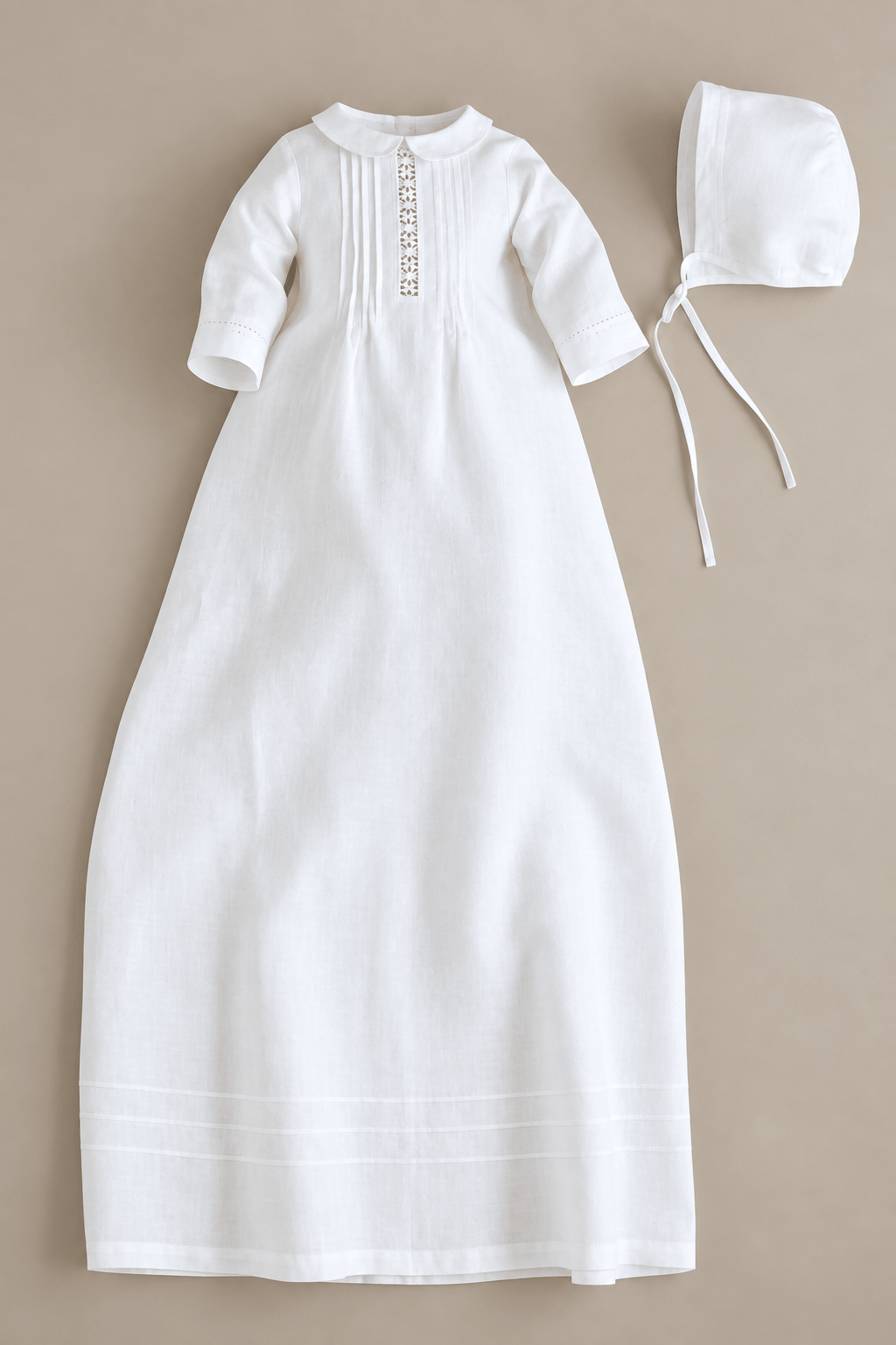 A white long baby christening dress with short sleeves and a decorative vertical embroidered neckline, shown flat on a beige background with a matching white bonnet.